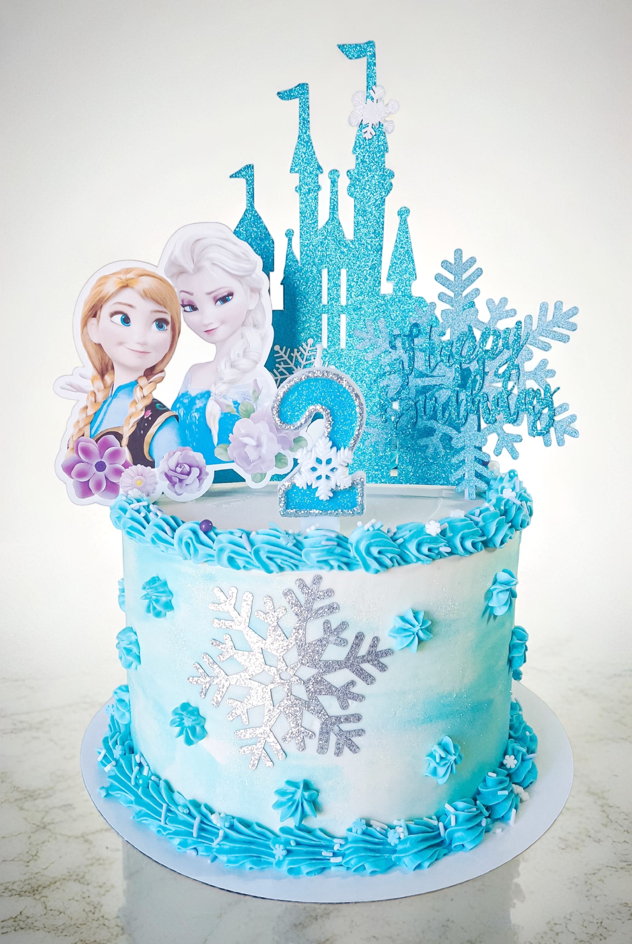 Frozen birthday cake with castle topper