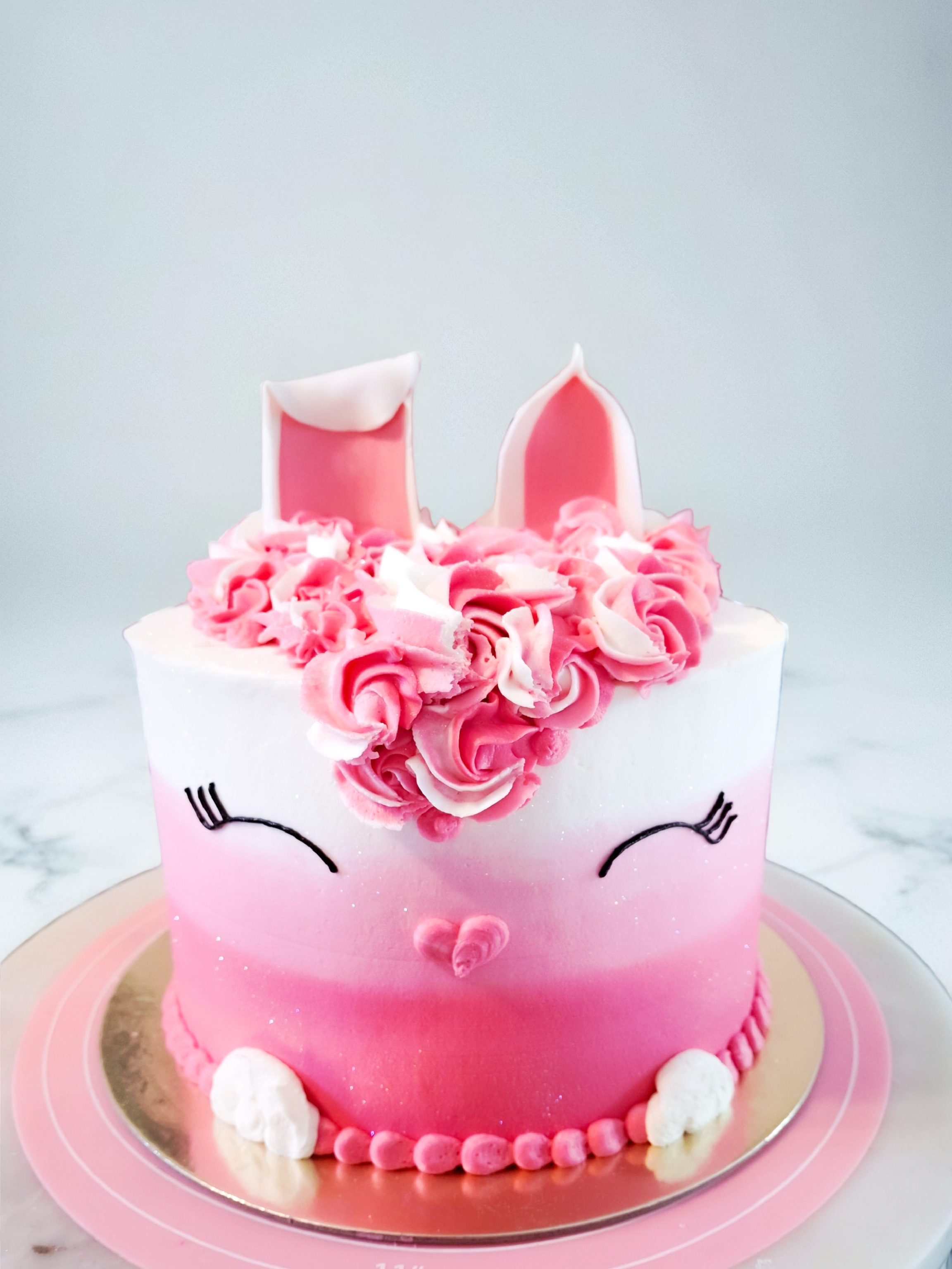 Pink unicorn cake with floral crown