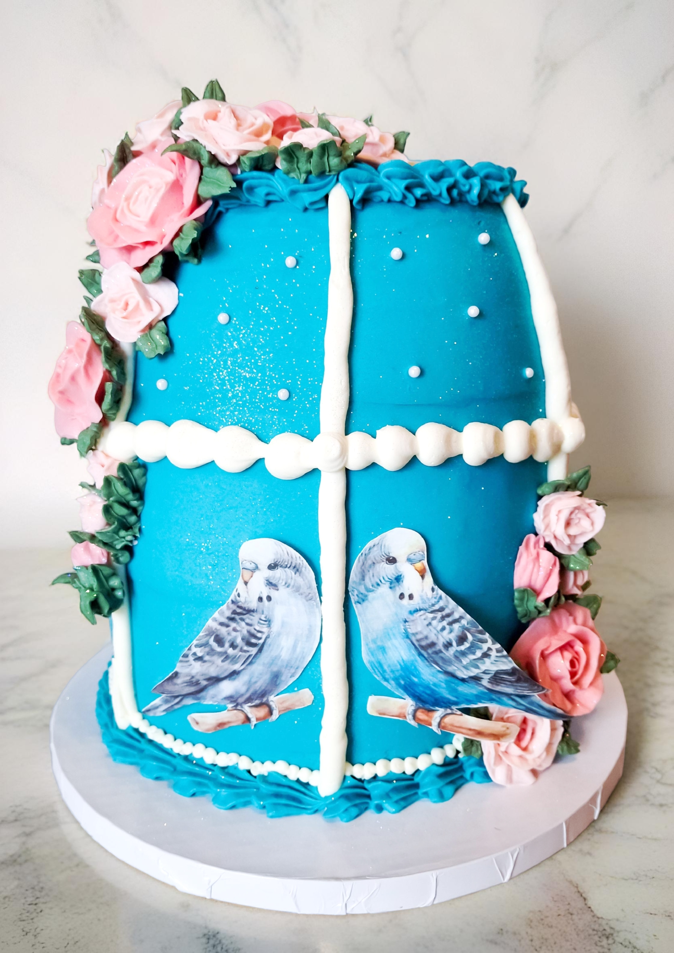 Turquoise cake with budgies and pink roses
