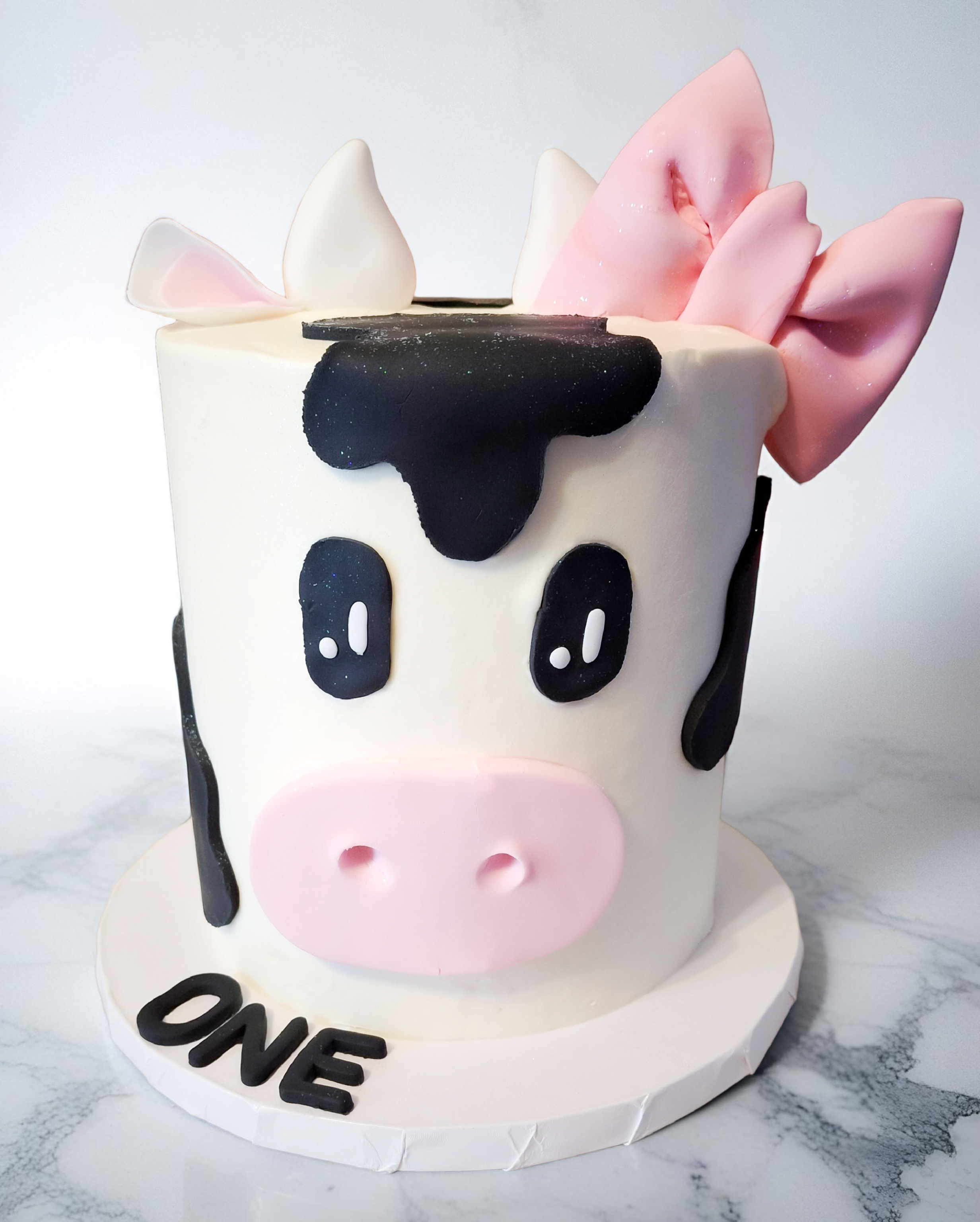 Cow face birthday cake with pink flowers